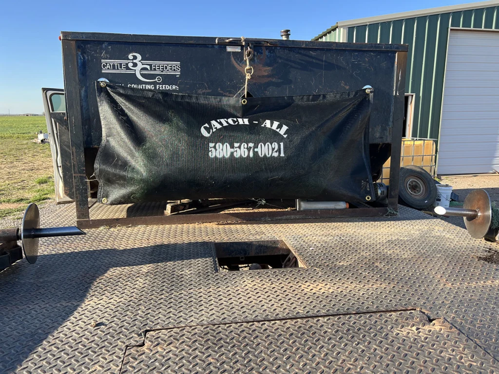 The Catch All, a durable woven nylon net, secured on a pickup bed to prevent net wrap and feed stacks from blowing off during transport.