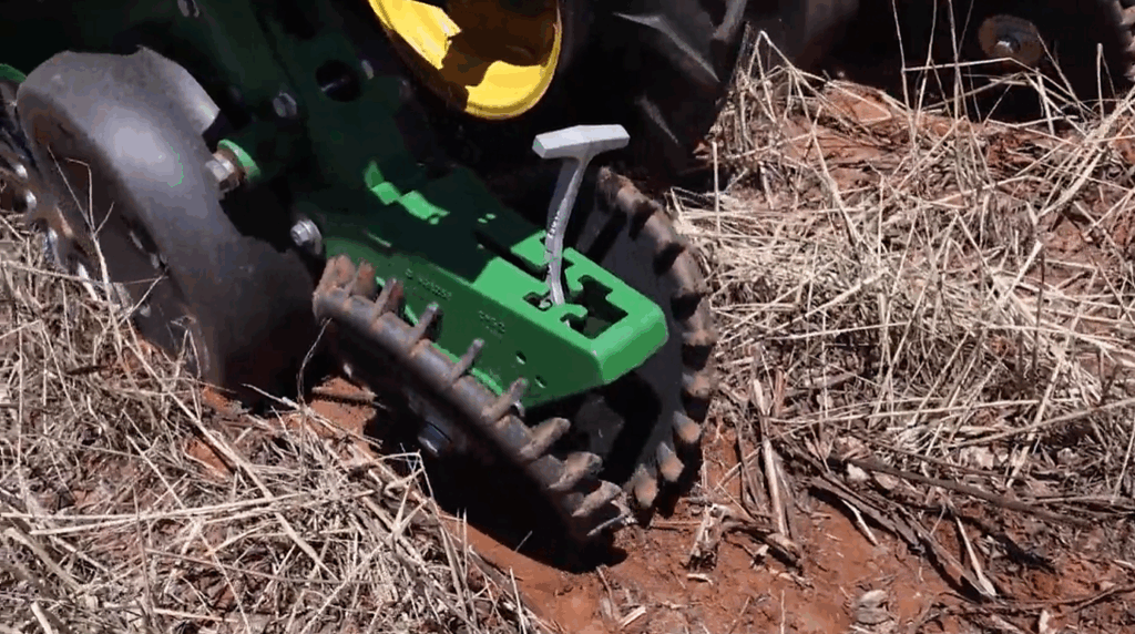 Close-up of a heavy-duty planter closing wheel in action during no-till planting