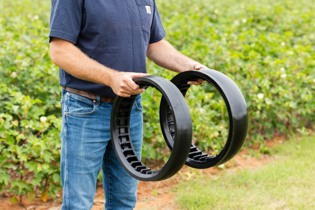 Farmer Holding Planter Gauge Wheels for Inspection