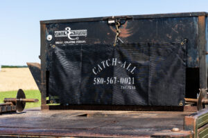 Catch-All attached to flatbed equipment on a ranch truck, showing how this durable tool simplifies cleanup and organizes gear for ranchers.