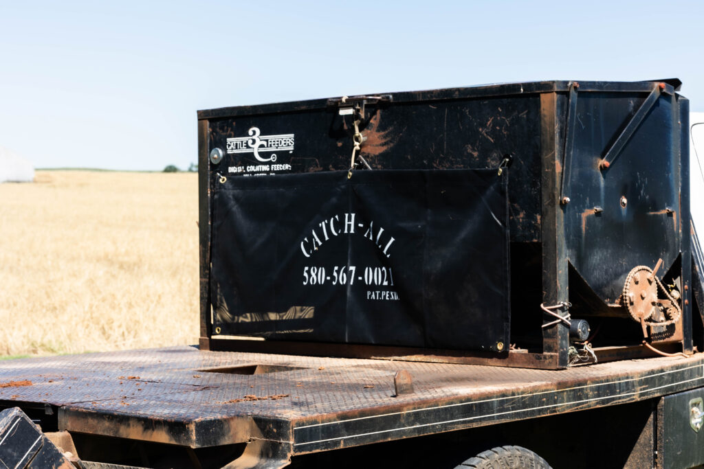 The Catch-All mounted securely to flatbed equipment, showing how ranchers use it to contain net wrap and reduce cleanup time.