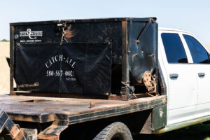 Catch All installed on flatbed equipment truck setup managing hay bale netting and organizing farming supplies on active flatbeds.
