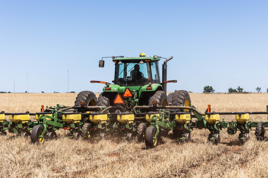No till farming equipment including no till planter operating across field with seeder machine and no till seed drill system