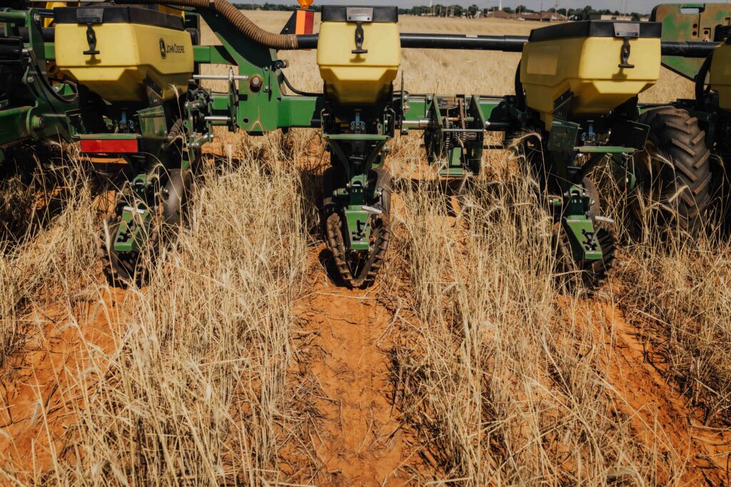 No till farming planter using no till equipment during no till planting in crop residue for environmentally friendly farming