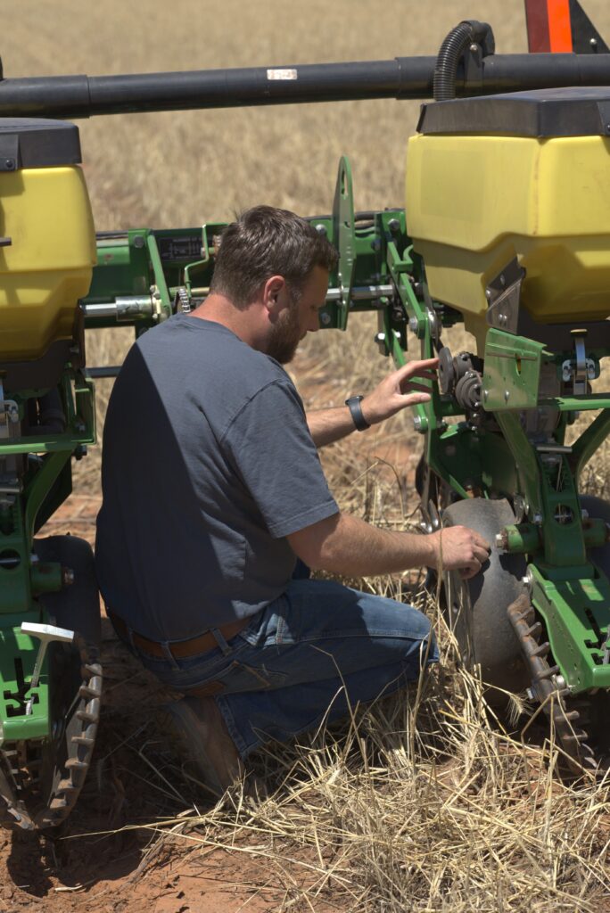 Inspecting planter gauge wheels for proper contact during planter maintenance checklist
