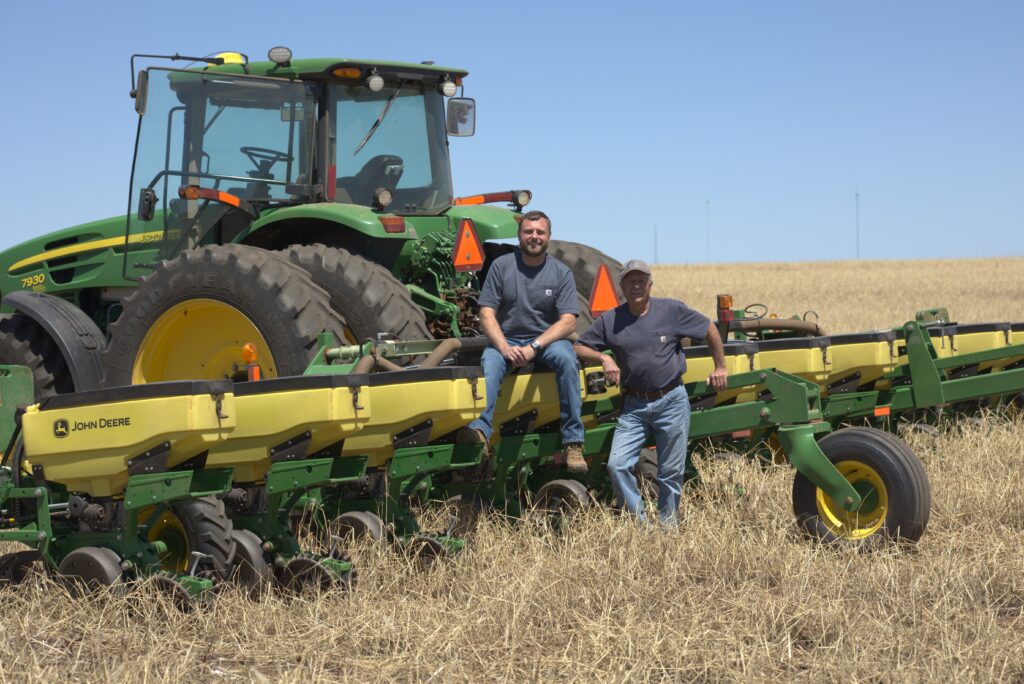 Farmer inspecting planter components during planter maintenance checklist before planting season