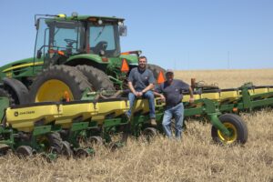 Farmer inspecting planter components during planter maintenance checklist before planting season