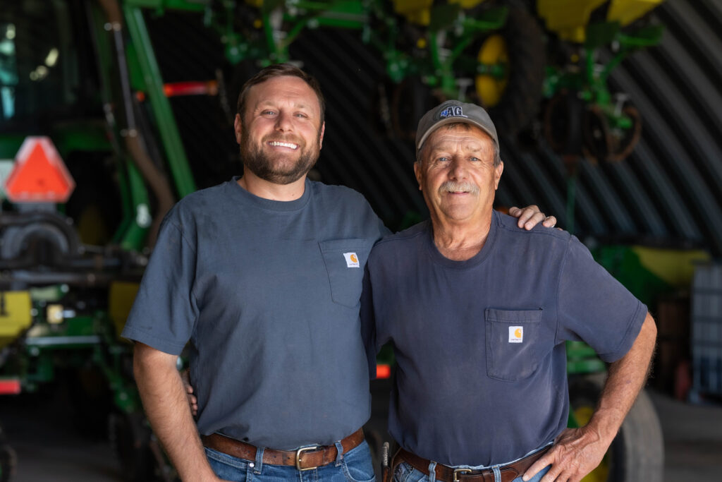 Employees standing inside an Oklahoma manufacturing shop with agricultural equipment made in the United States by experienced agriculture equipment manufacturers and farm equipment suppliers.