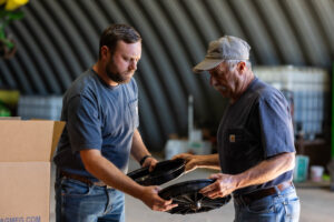 Team members at an Oklahoma manufacturing facility inspecting planter components and agricultural parts made in the United States by trusted agriculture equipment manufacturers and farm equipment suppliers.