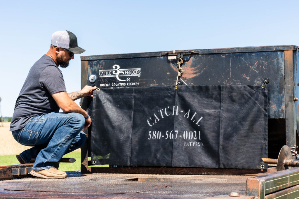 4AG Catch-All mounted on ranch equipment for convenient net wrap storage that keeps loose hay bale netting contained during feeding runs.